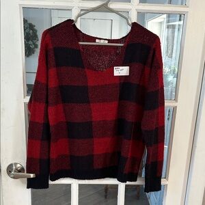Q24.    Maunces Red and Black V-Neck Sweater